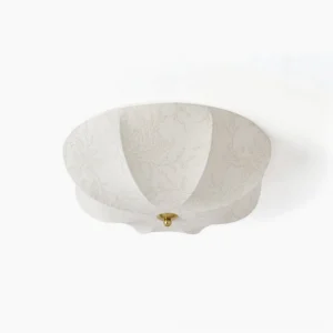 Orchid fabric ceiling light flat lay studio shot showing off-white scalloped shade with botanical floral print and brass metal base
