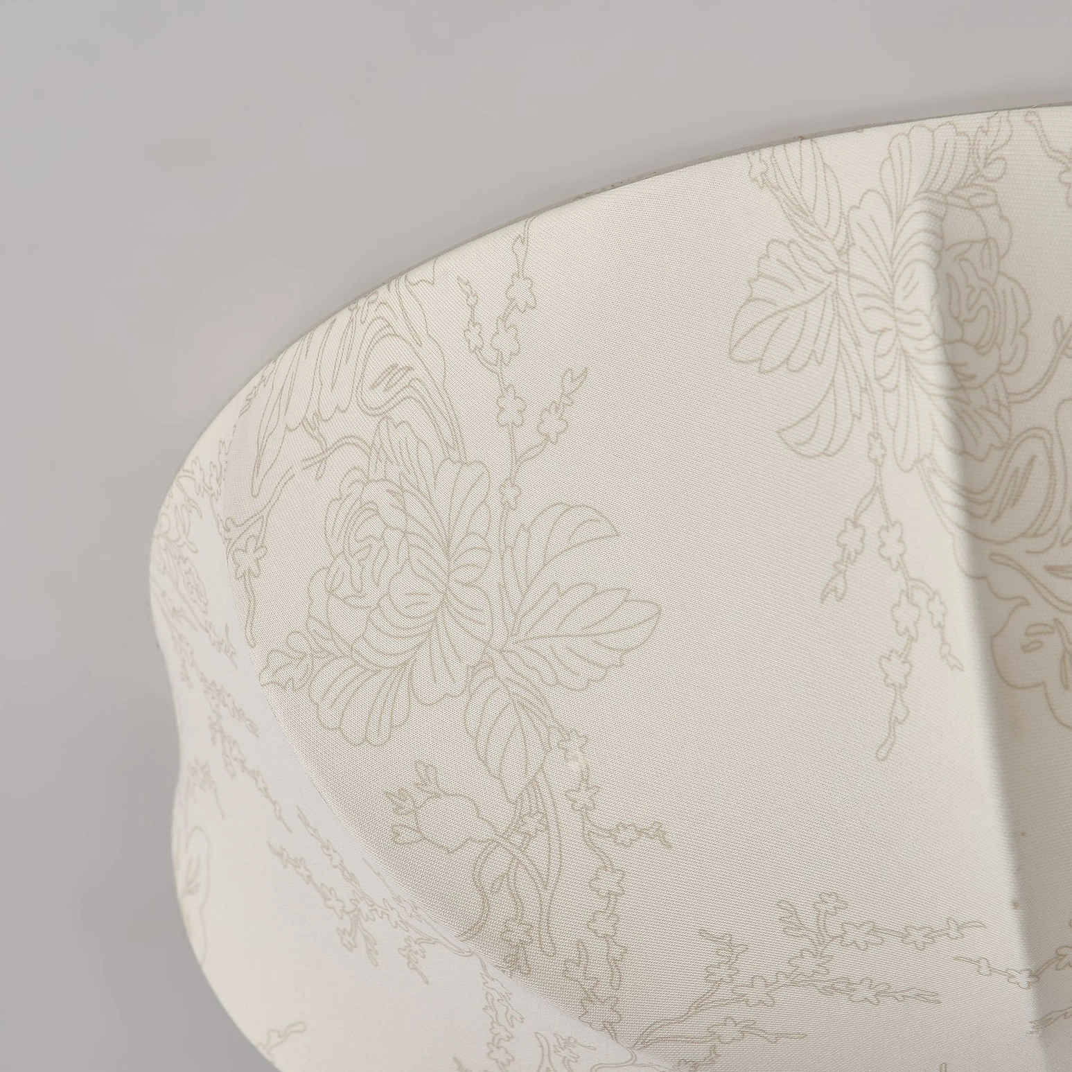 Close-up detail of orchid fabric lamp shade showing delicate line art floral print and soft woven textile texture
