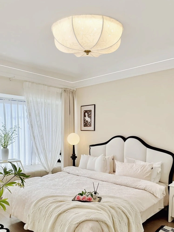 Elegant vintage bedroom with orchid ceiling light establishing romantic French country aesthetic with refined furnishings