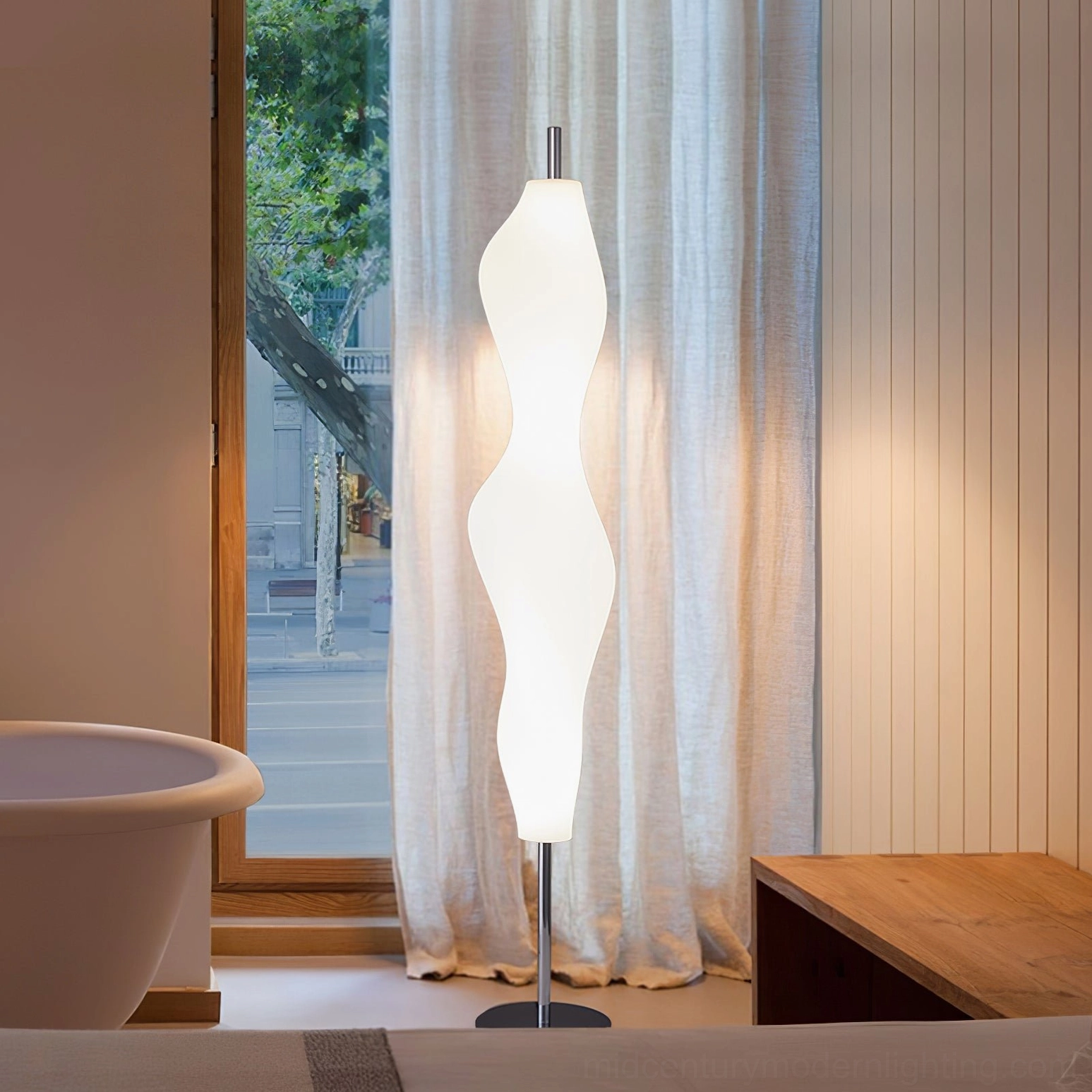 Sculptural biomorphic lamp in cozy home setting with bathtub and wood furniture