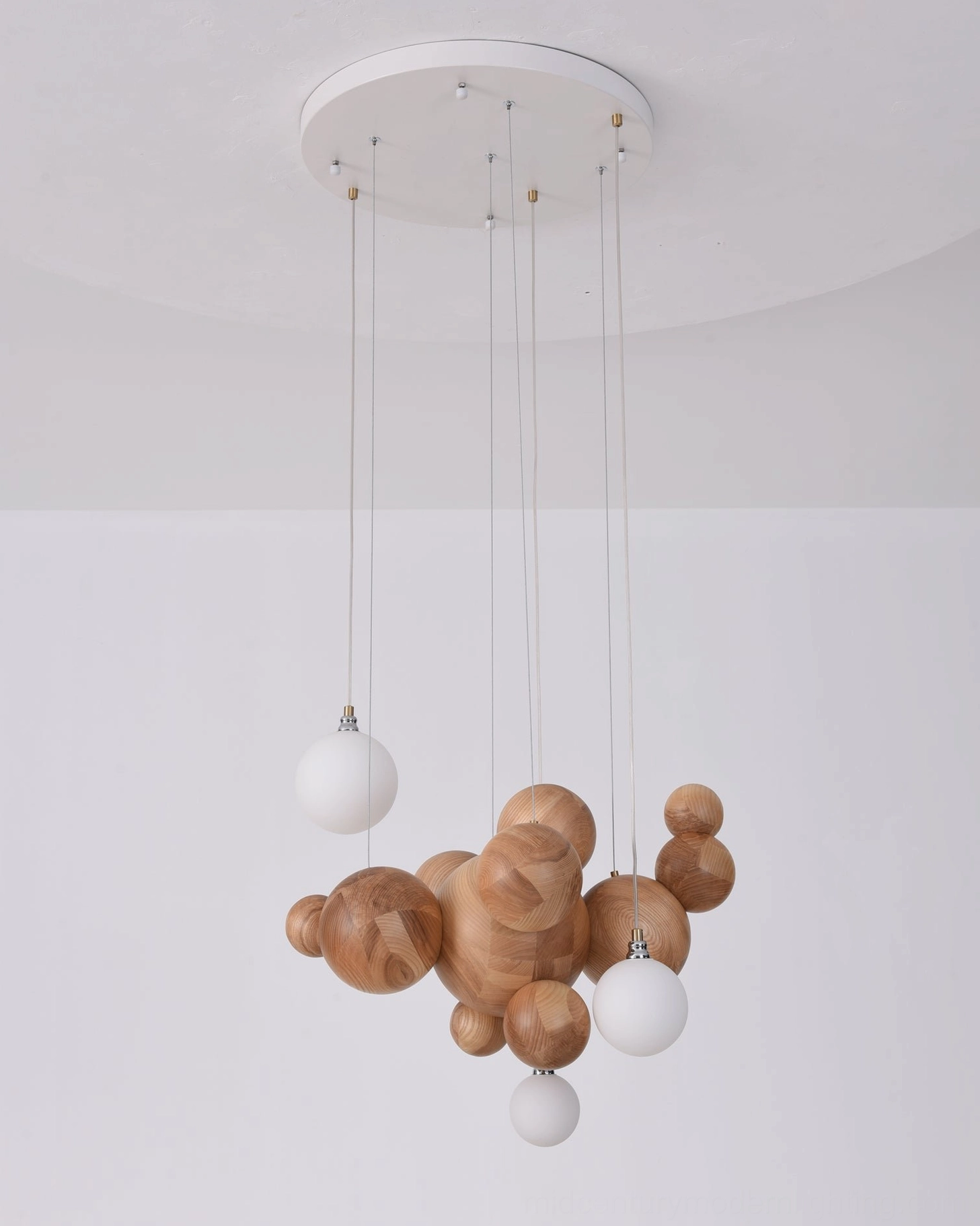Sculptural wood sphere chandelier demonstrating organic modernist design principles with natural wood finish and warm lighting