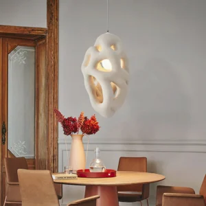 Organic nest pendant hanging in vintage dining room, creating ambient shadow play on wall, contemporary pendant light