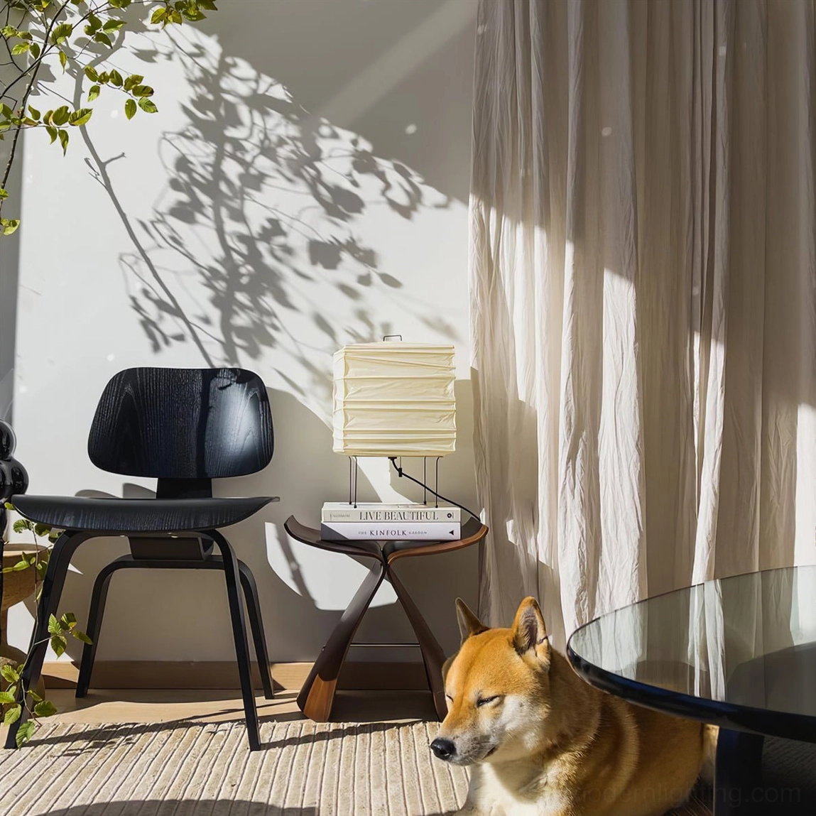 Handmade washi paper lamp in cozy Scandinavian home setting with sheer curtains and decorative dog figurine, hygge-inspired ambient lighting