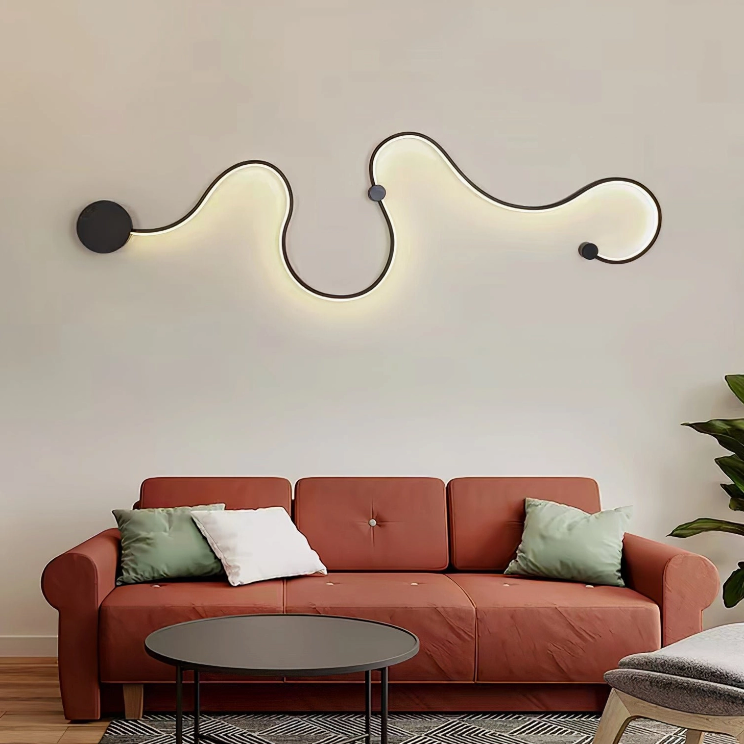 Sculptural snake wall sconce with undulating curves mounted on living room wall near red sofa