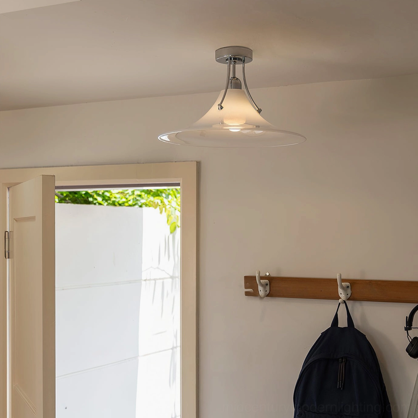 Orient ceiling light fixture in entryway with wooden coat rack showing same lamp series design and sleek profile