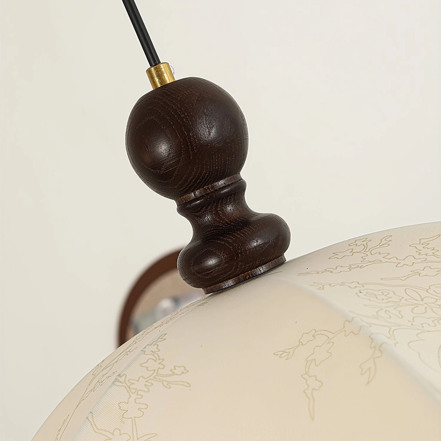 Oriente pendant light hardware detail close-up, dark stained walnut wood with brass mounting accent