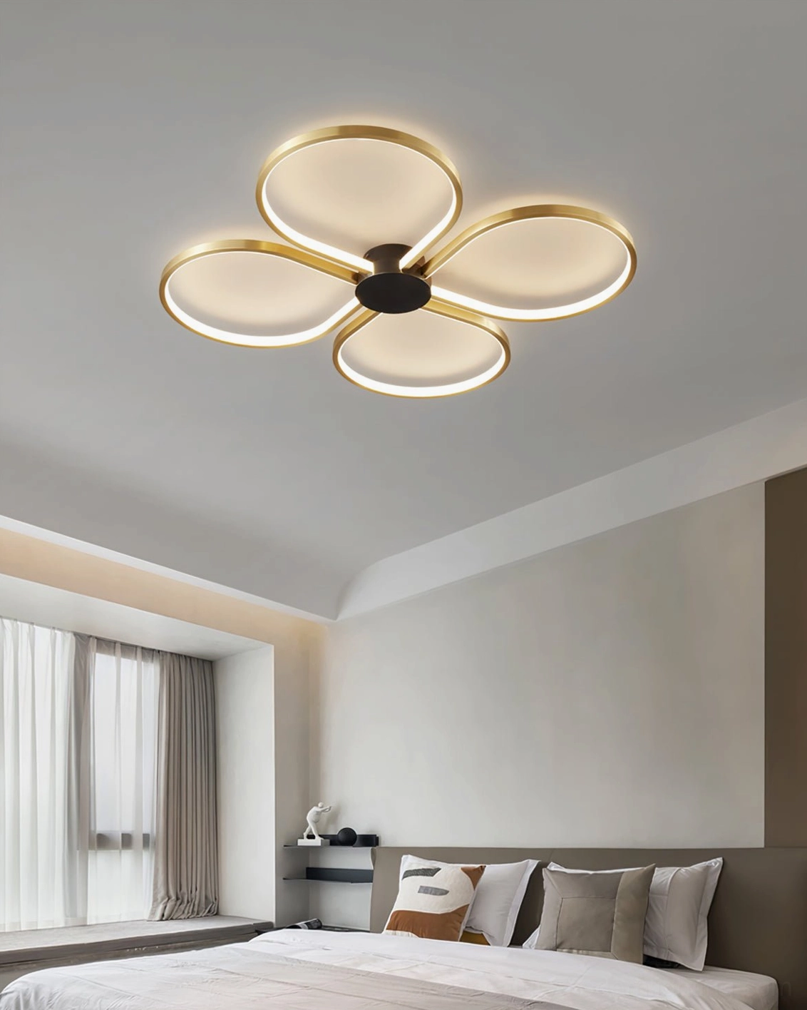 Orion LED flush-mount ceiling lamp in minimalist master bedroom, soft warm glow creating cozy ambiance above simple bedding