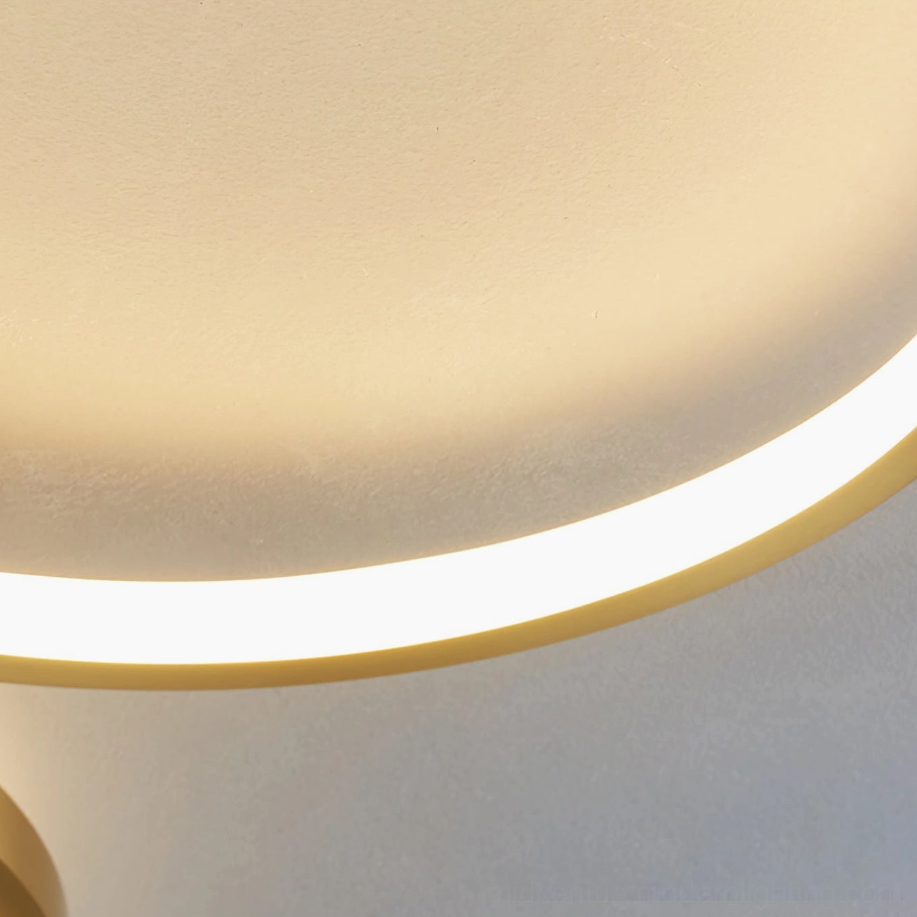 Close-up detail of Orion ceiling lamp curved acrylic LED light panel, warm white integrated LED strips visible, overhead studio view