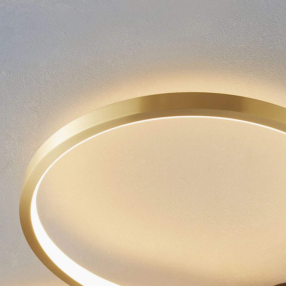 Orion modern minimalist ceiling lamp showing integrated LED warm white light distribution, petal geometry creating elegant shadow patterns