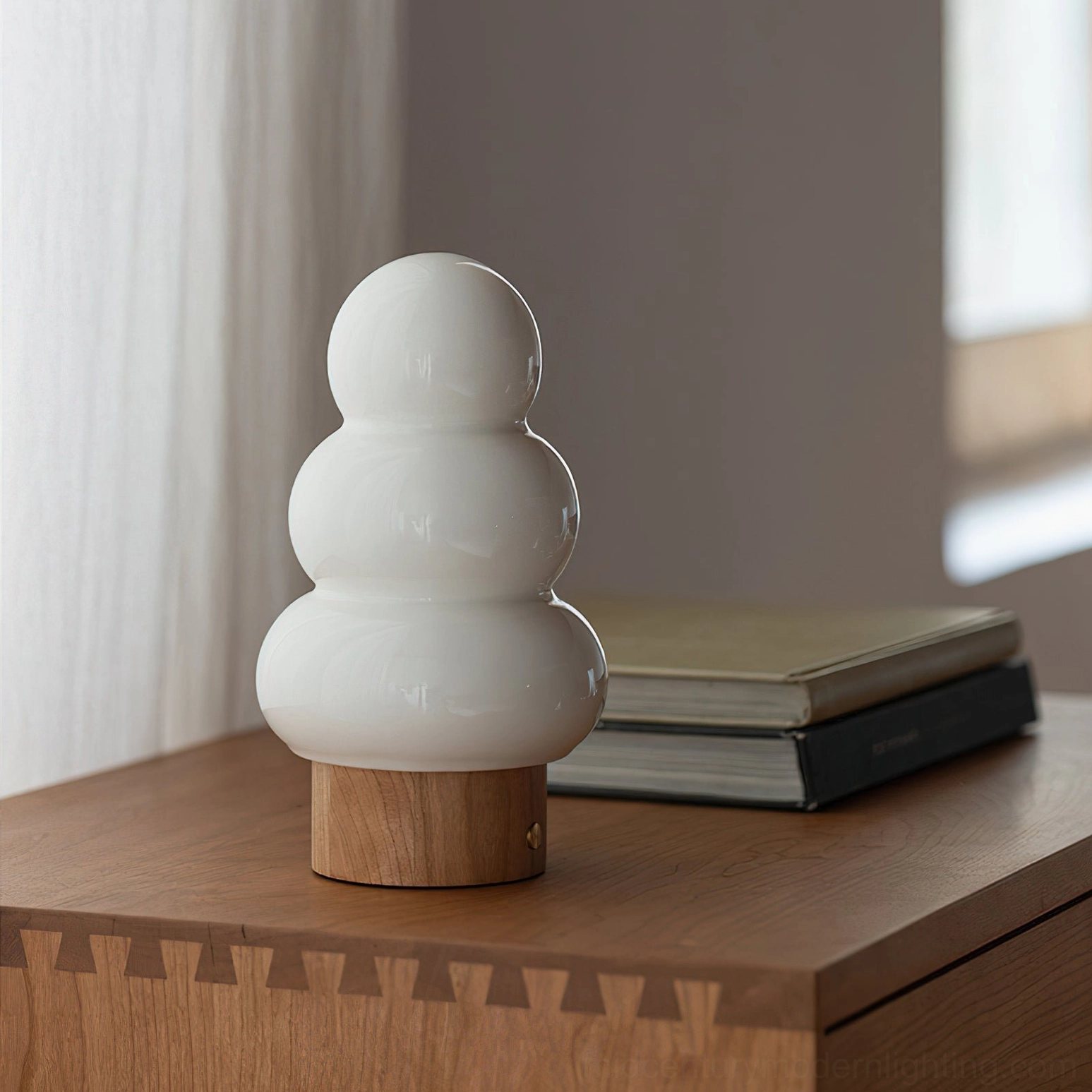 Orlo ceramic table lamp detail view showing stacked glass diffuser layers and natural wood base material