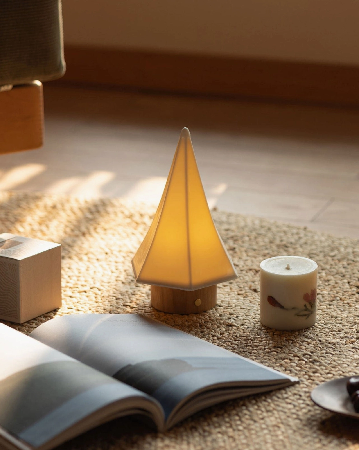 Orlo ceramic table lamp minimalist living room setting woven rug with candle and open book styling