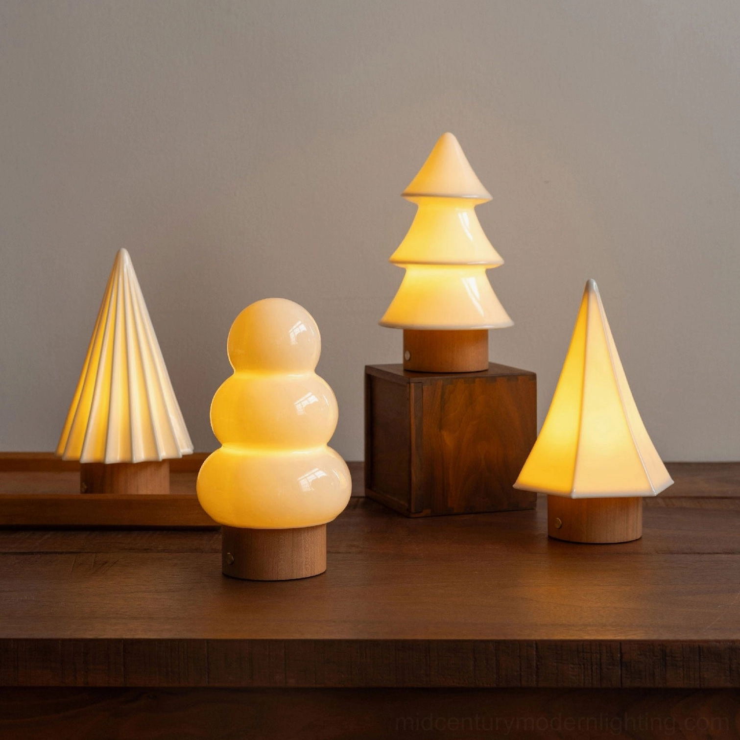 Orlo ceramic table lamp multiple size models showing proportional design variations on wooden table