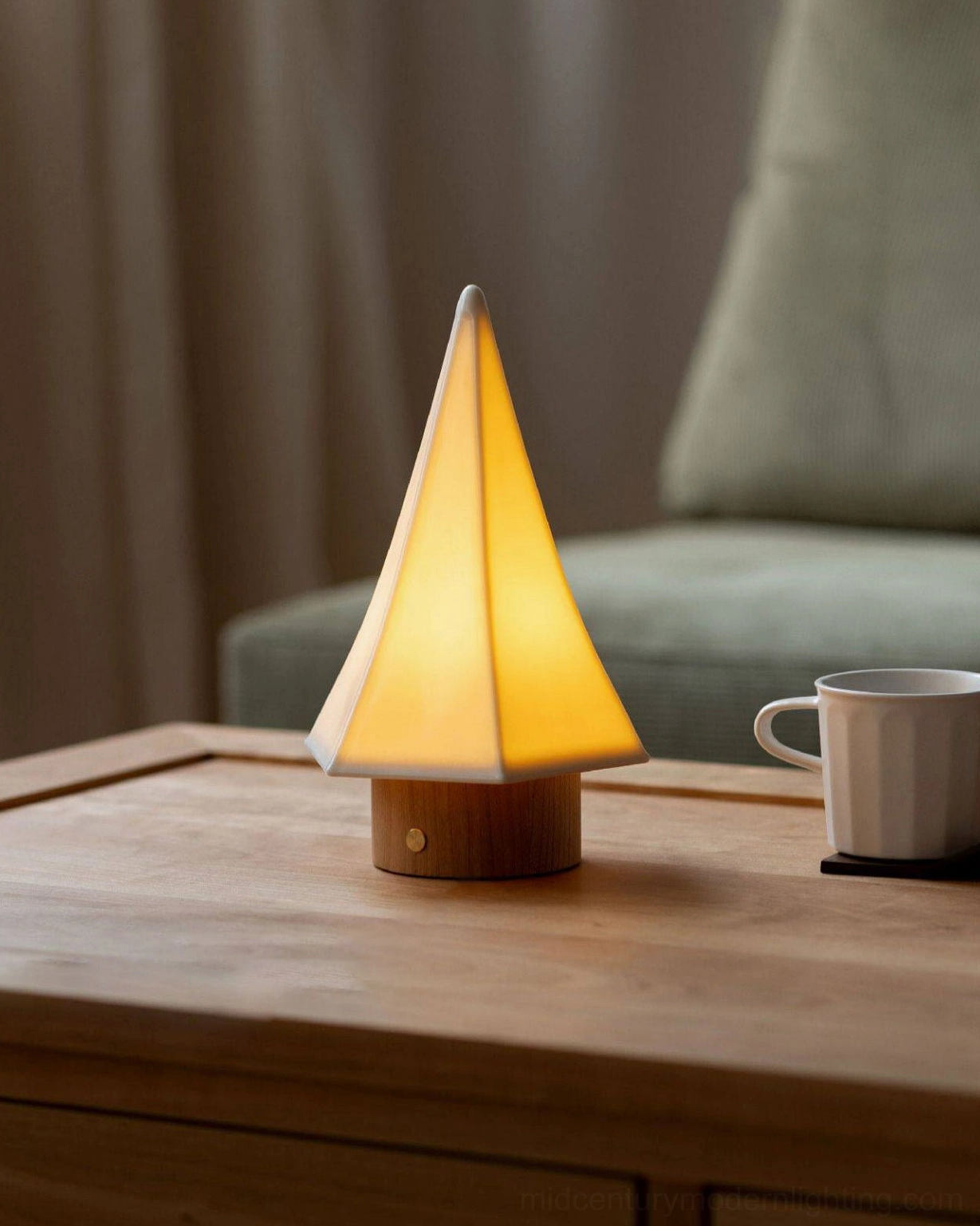 Orlo ceramic table lamp on sofa side table with white ceramic mug and warm minimalist interior