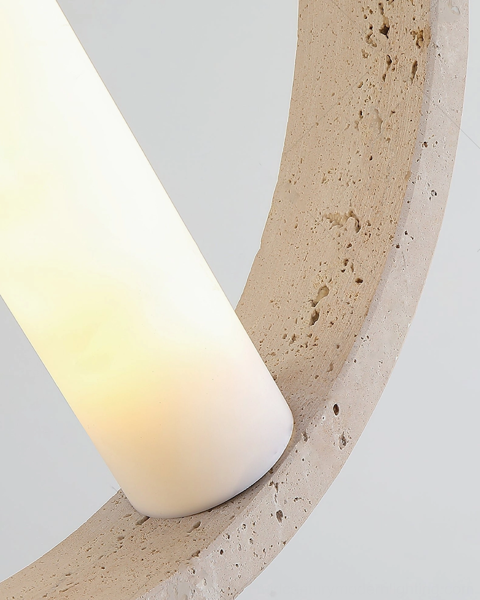 Orvion modern pendant fixture showing travertine ring frame with integrated warm LED light emission