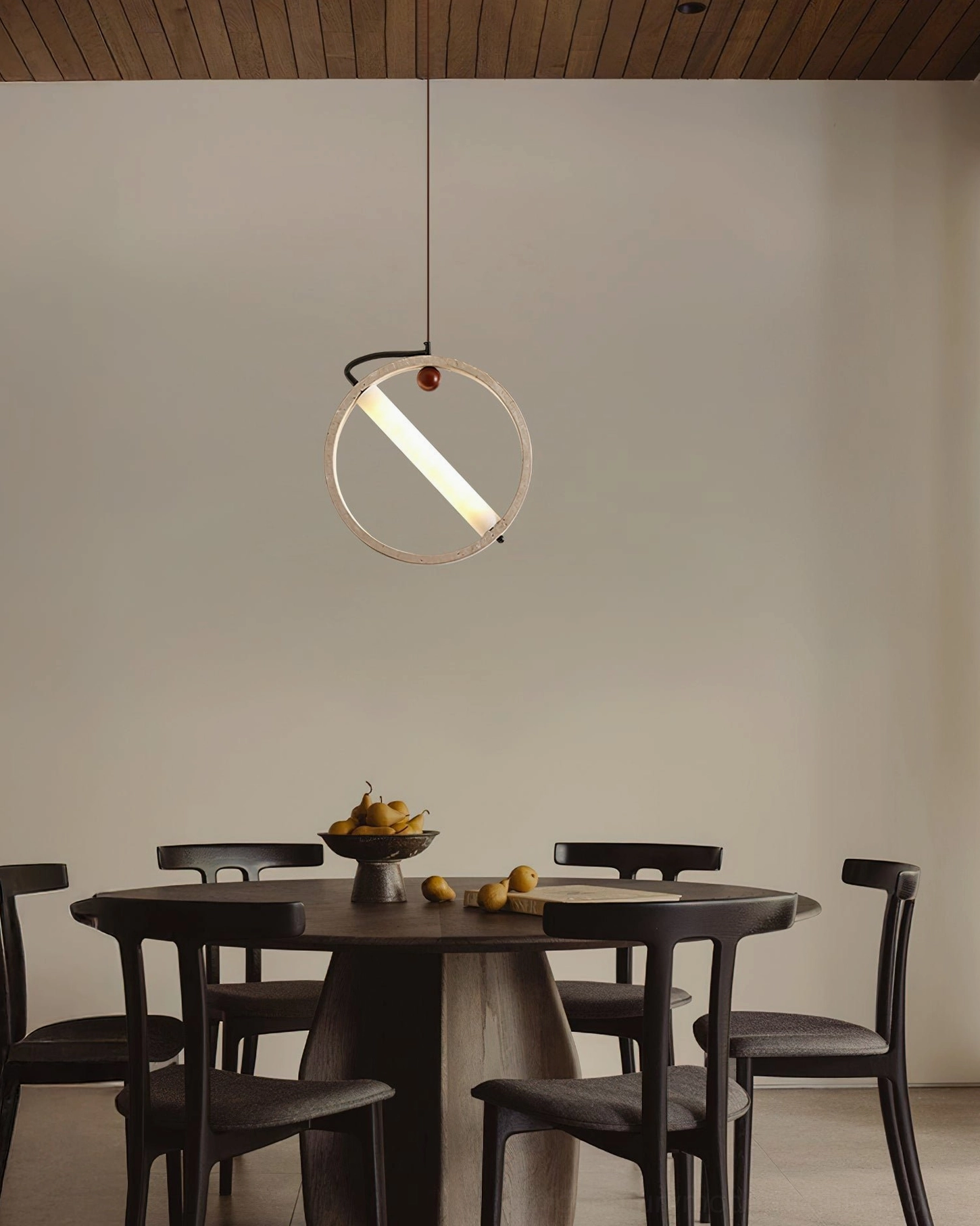 Orvion pendant light fixture suspended above dark wood round dining table mid-century modern setting