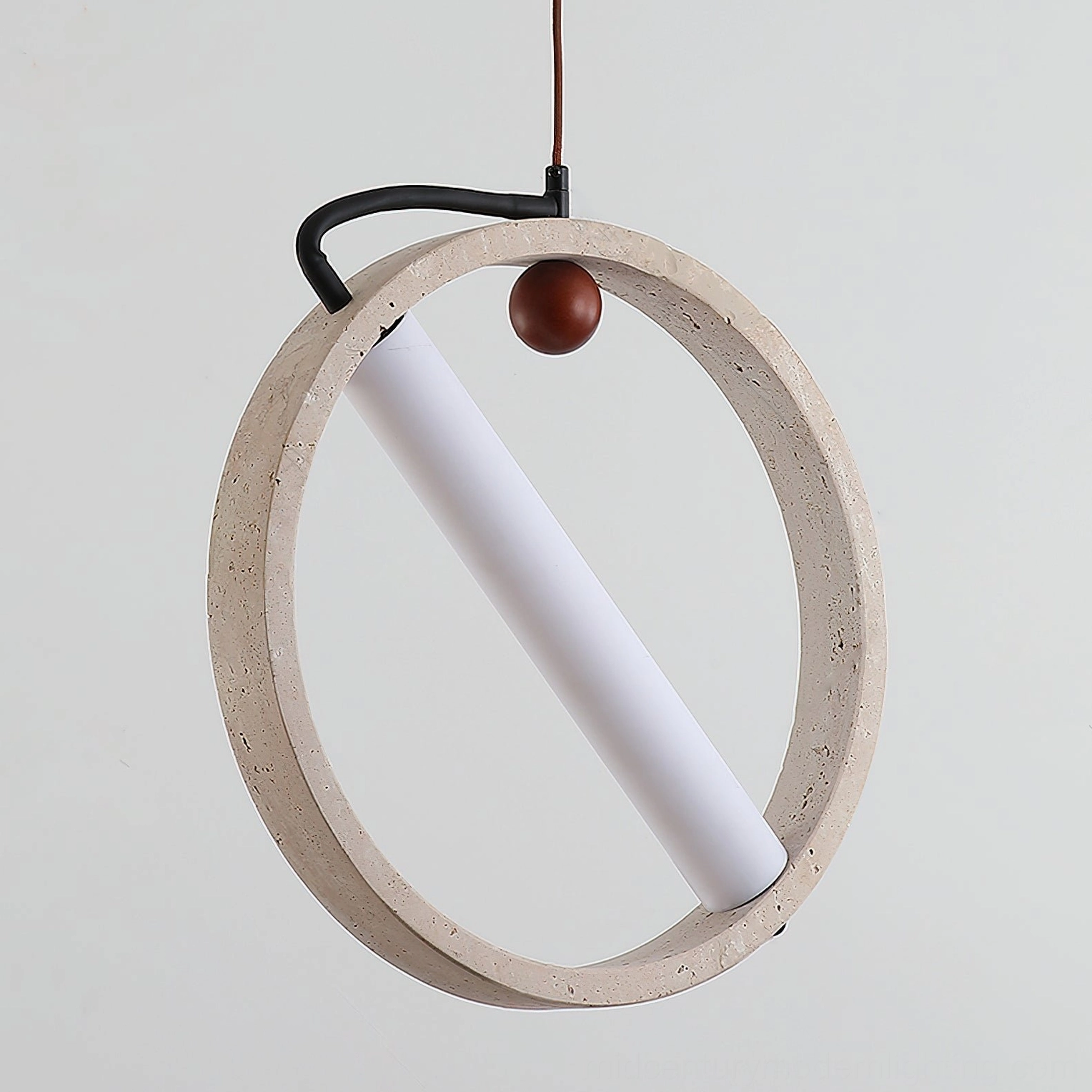 Close-up detail of Orvion travertine pendant showing natural stone texture walnut accent and LED core