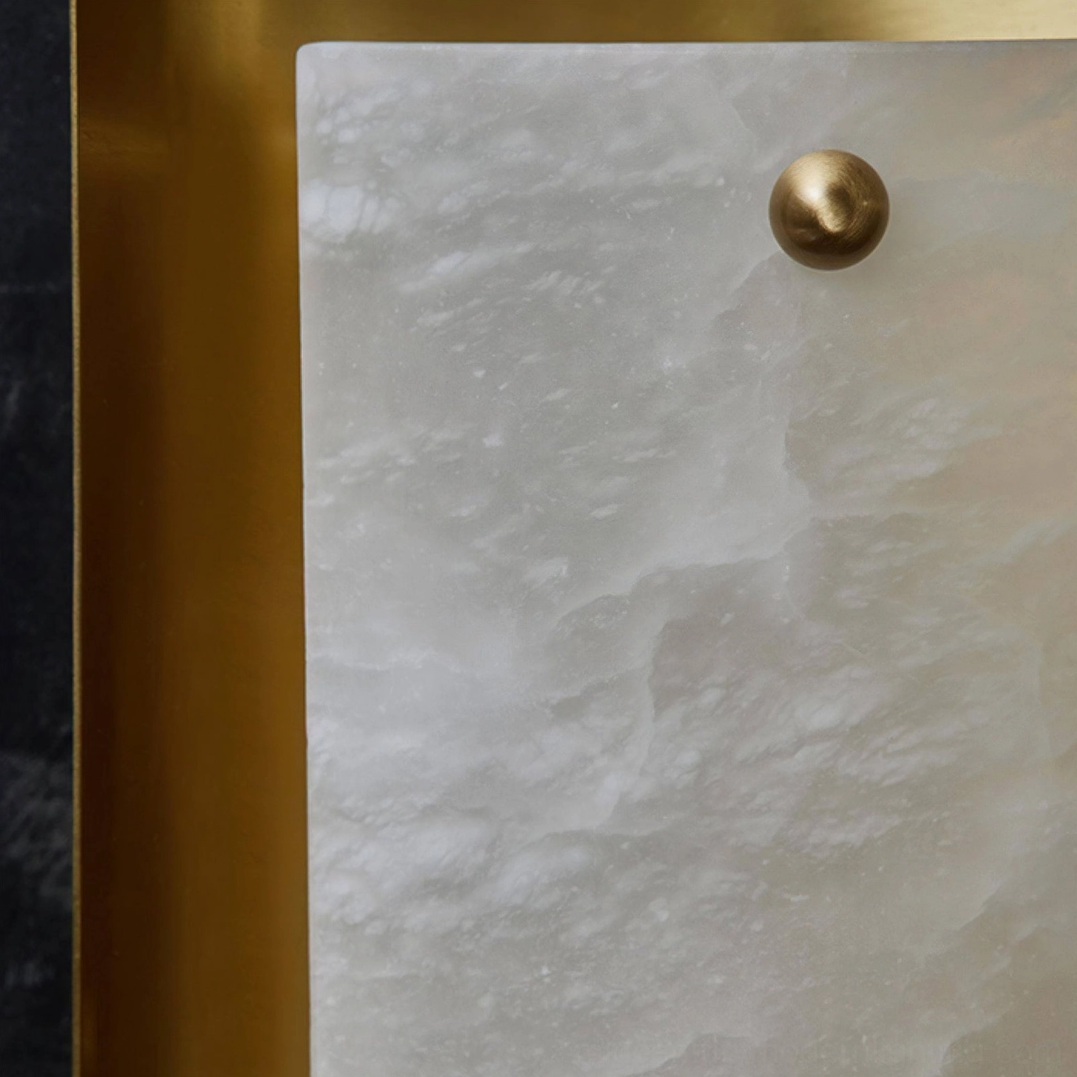 Extreme close-up of natural alabaster stone panel texture showing unique grain and translucency of Osman sconce