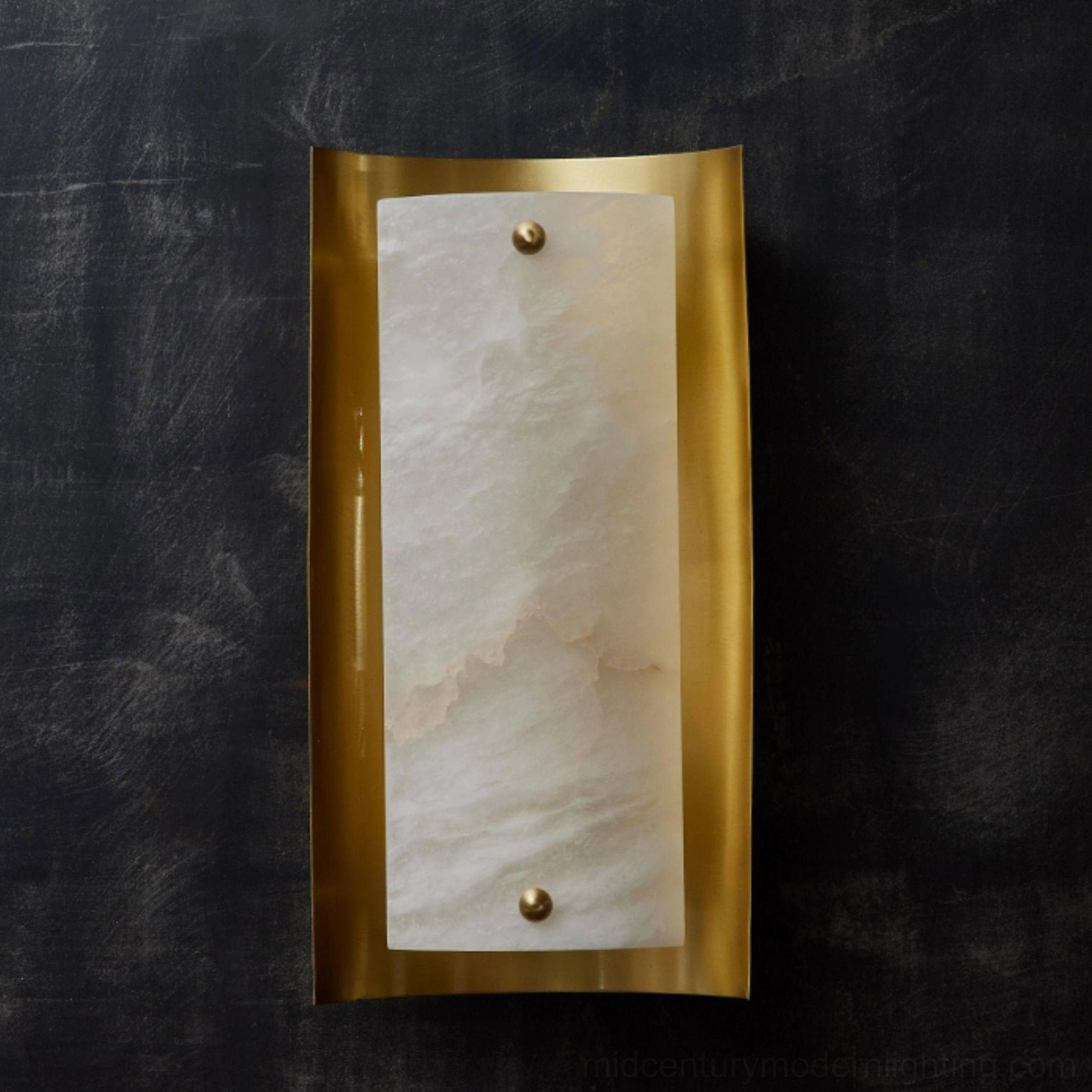 Osman Alabaster Wall Lamp mounted on dark textured wall showing curved brass frame detail and mounting hardware