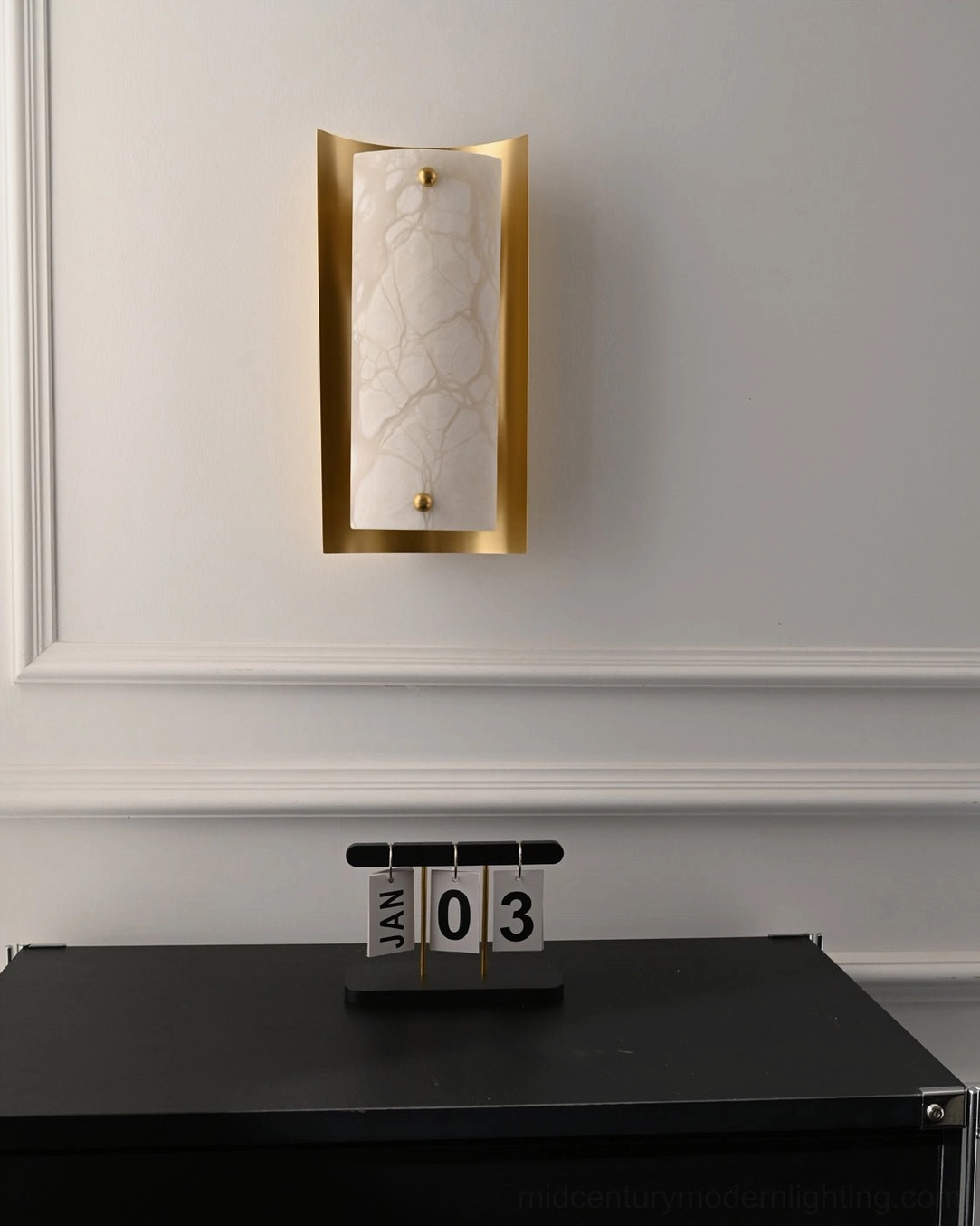 Osman Alabaster Wall Lamp creating warm atmospheric lighting in contemporary interior with wainscoting and desktop décor