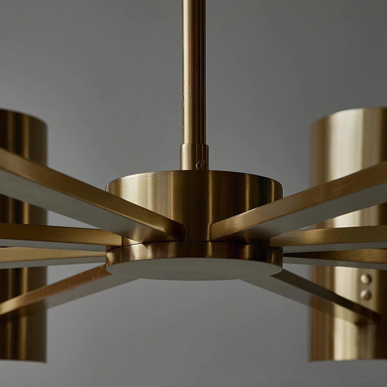Osman chandelier ceiling fixture hardware detail, brushed brass multi-arm structure with mechanical design, top-down view