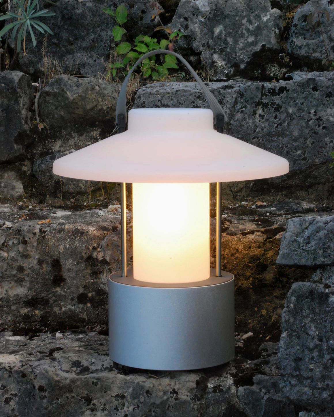 Matte silver frosted acrylic outdoor lamp on stone terrace landscape