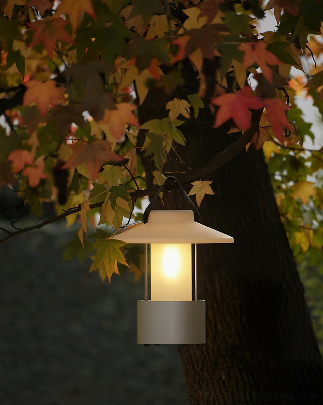 Cordless table lamp with grey base glowing under autumn maple tree foliage
