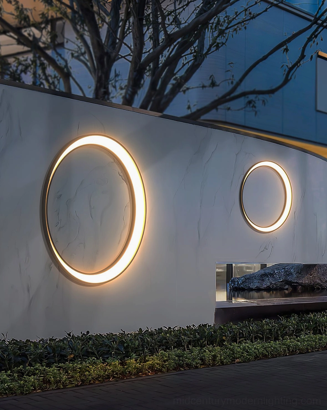 Contemporary circular outdoor wall lamp architectural detail showing precision engineering and weather-resistant construction