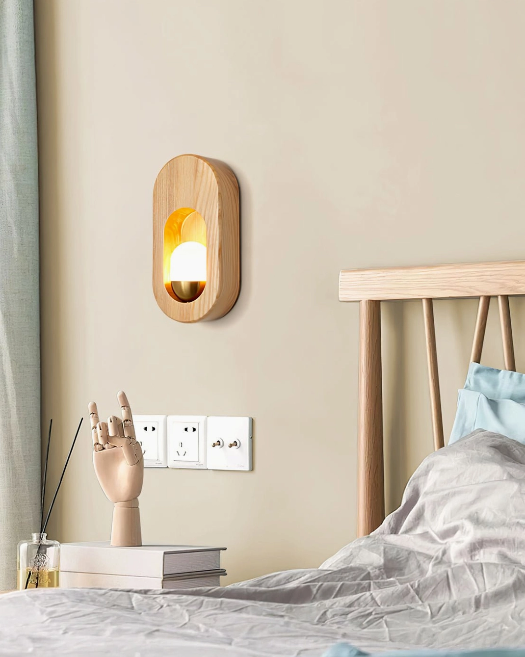 Side profile of oval wooden sconce beside bed showing natural wood texture and glass diffuser detail
