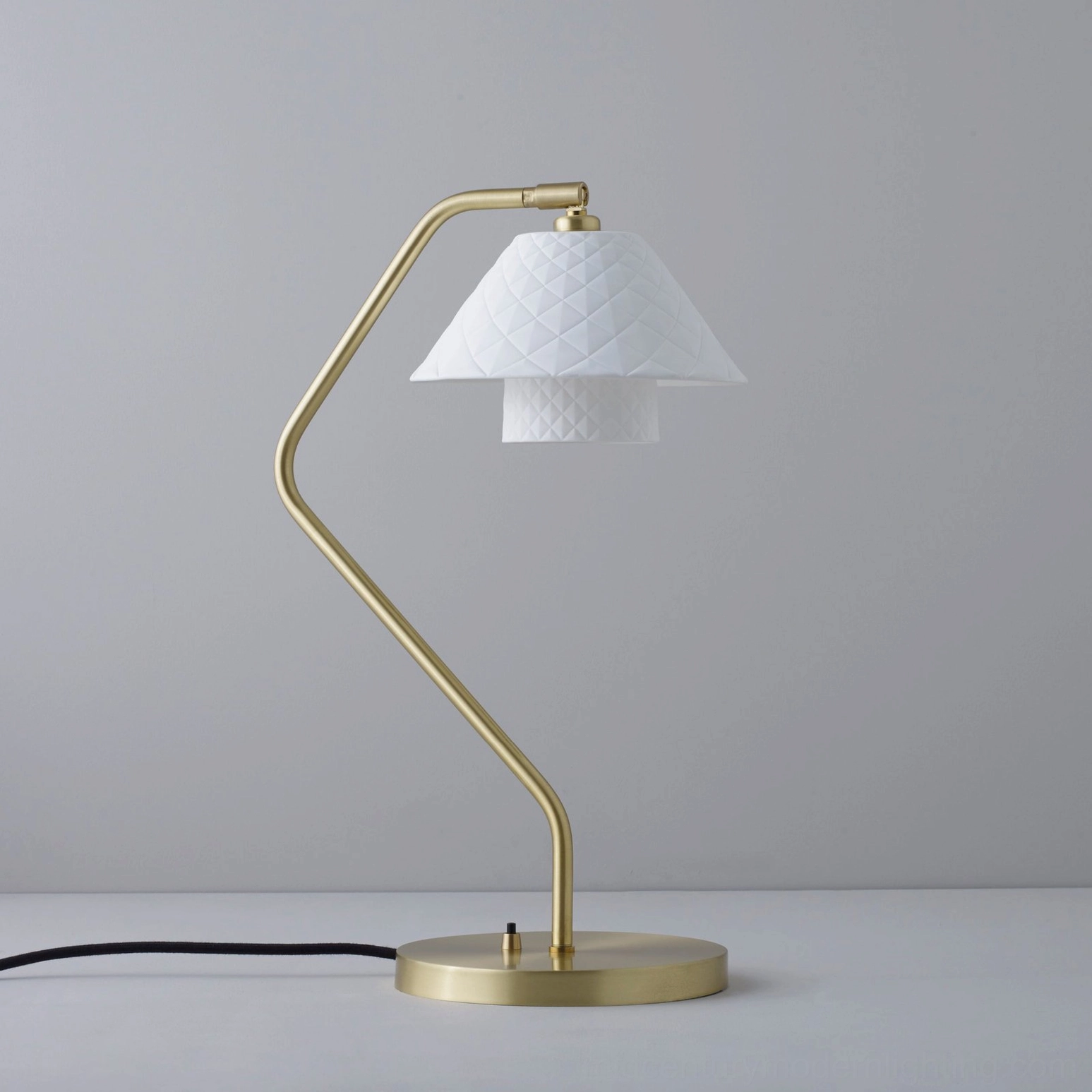 Oxford table lamp unlit showing compact zigzag gold stand and small quilted shade, architectural silhouette