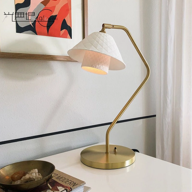 Oxford table lamp on minimalist white desk with wall art, modern workspace styling with warm light