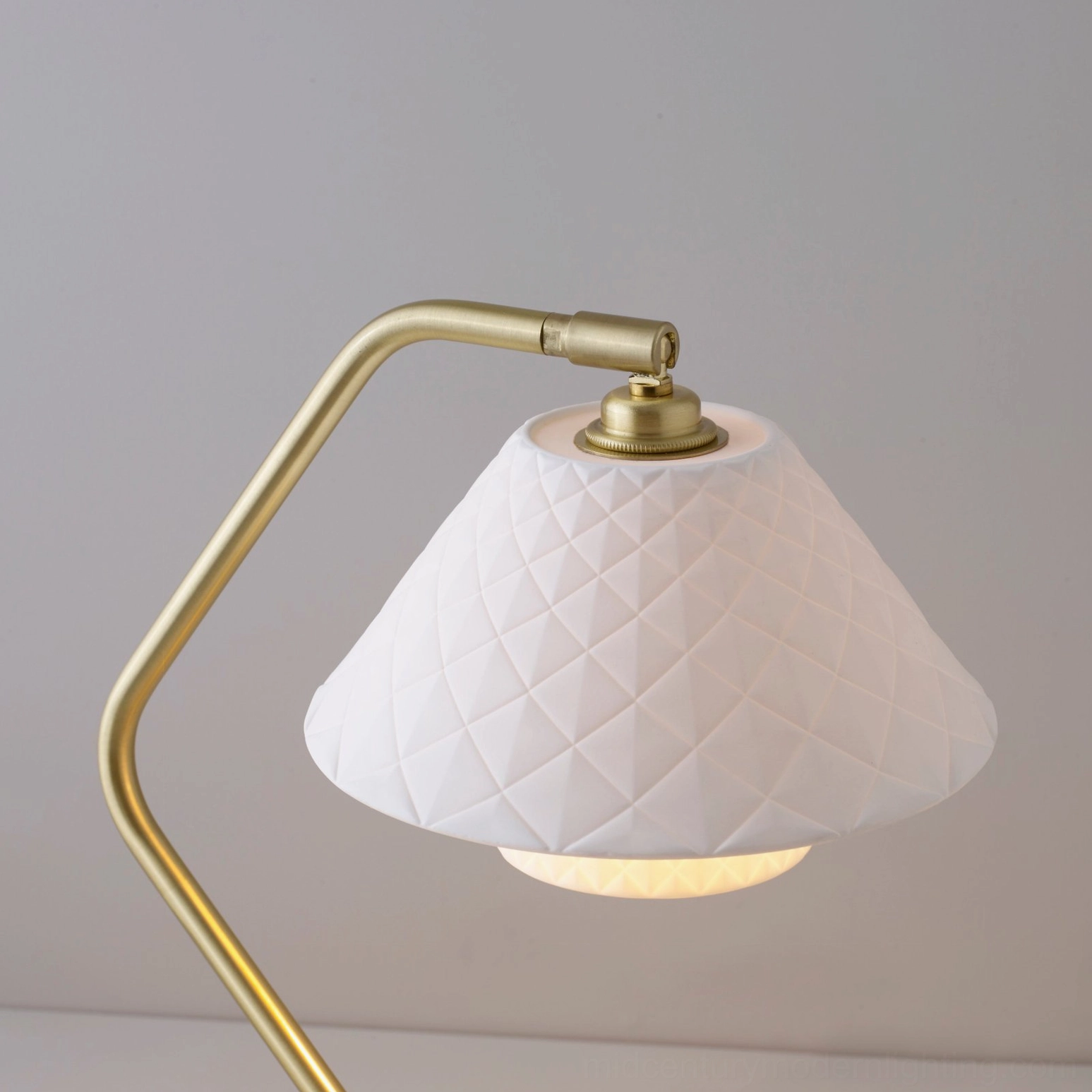 Close-up detail of Oxford lamp showing diamond-quilted texture on white bone china shade with gold curved arm