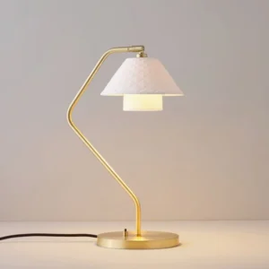 Oxford double table lamp illuminated, showcasing warm glow through textured bone china shades with curved brass frame