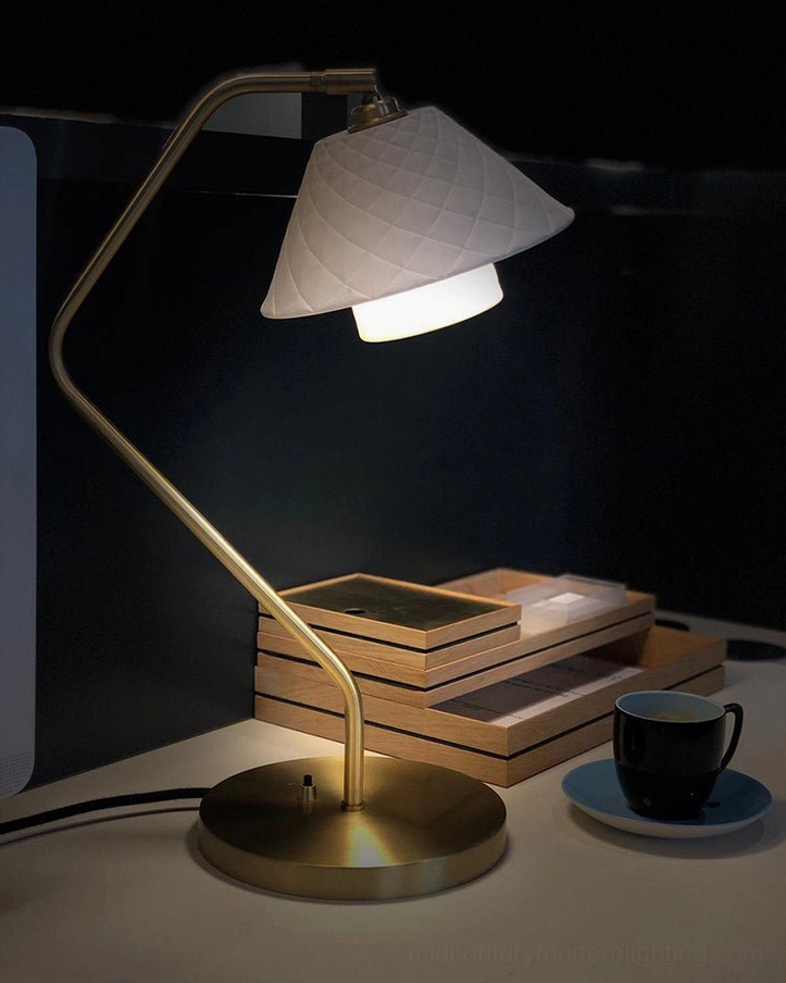 Oxford dual-shade lamp at night with stacked books and coffee cup, atmospheric desk ambiance