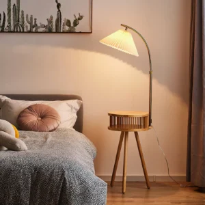 Ozawa mid-century modern floor lamp in bedroom setting with natural wood base and warm brass accents beside bed