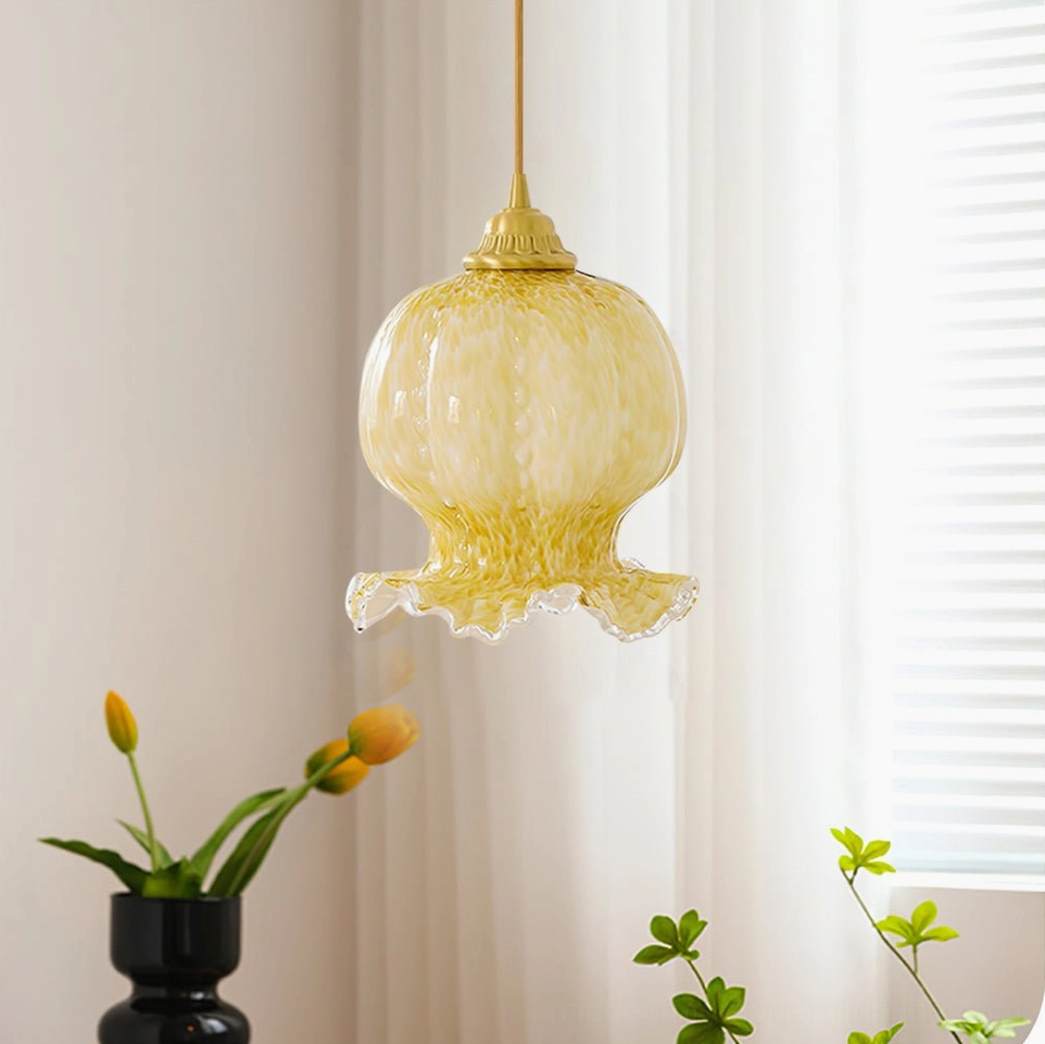 Hanging Ozera pendant light with bright natural lighting, tulip flowers in black vase, and small green plants