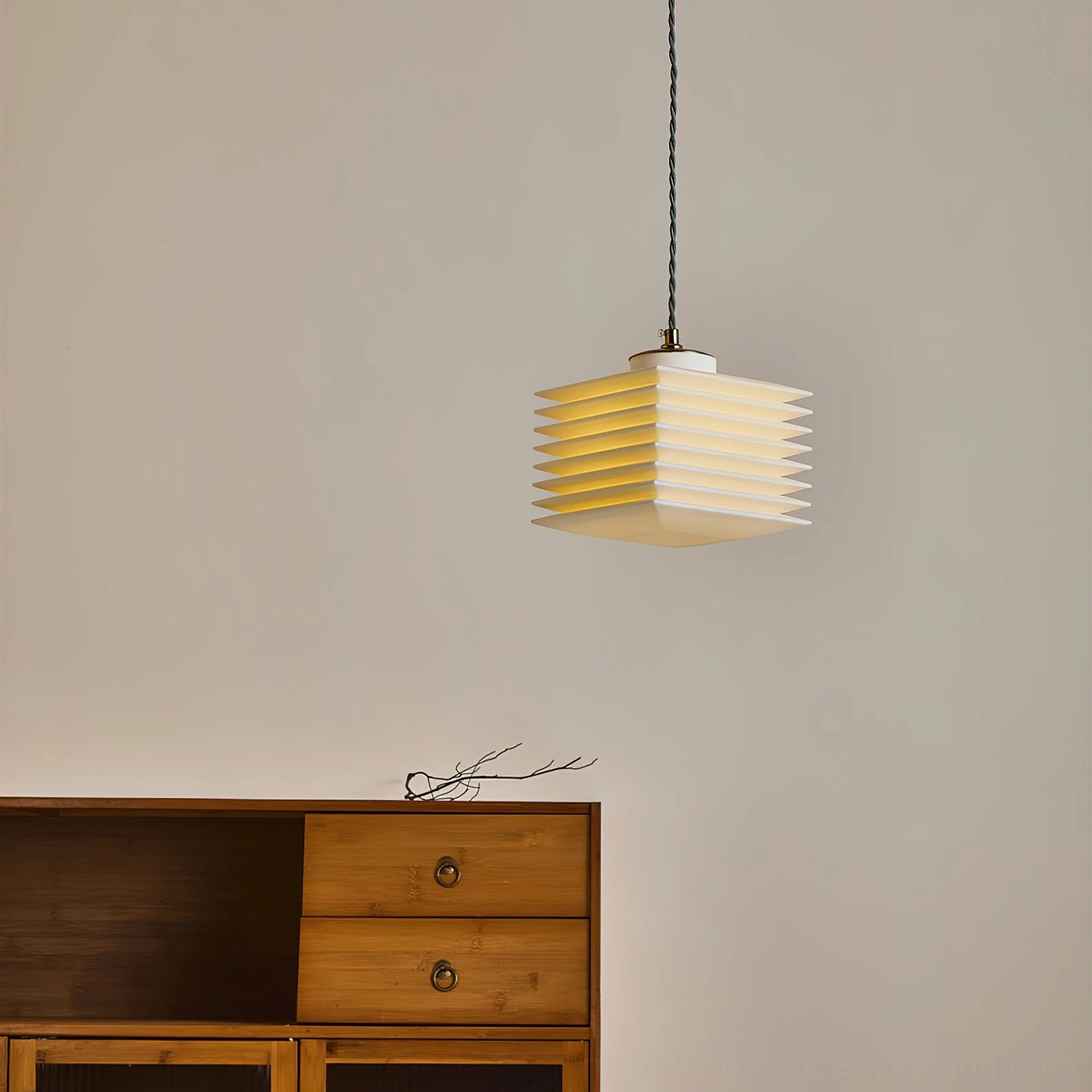 Pagoda pendant lamp fully illuminated showing geometric light distribution in minimalist interior