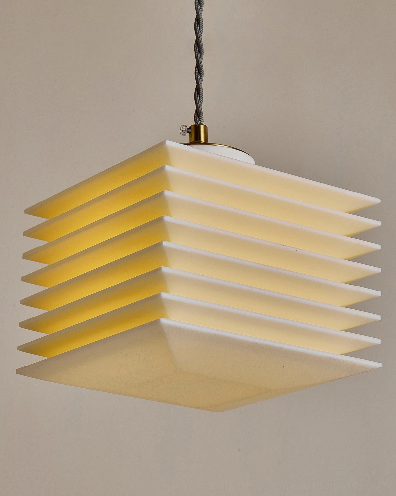 Close-up texture detail of pagoda pendant lamp ribbed panels with brass gold hardware