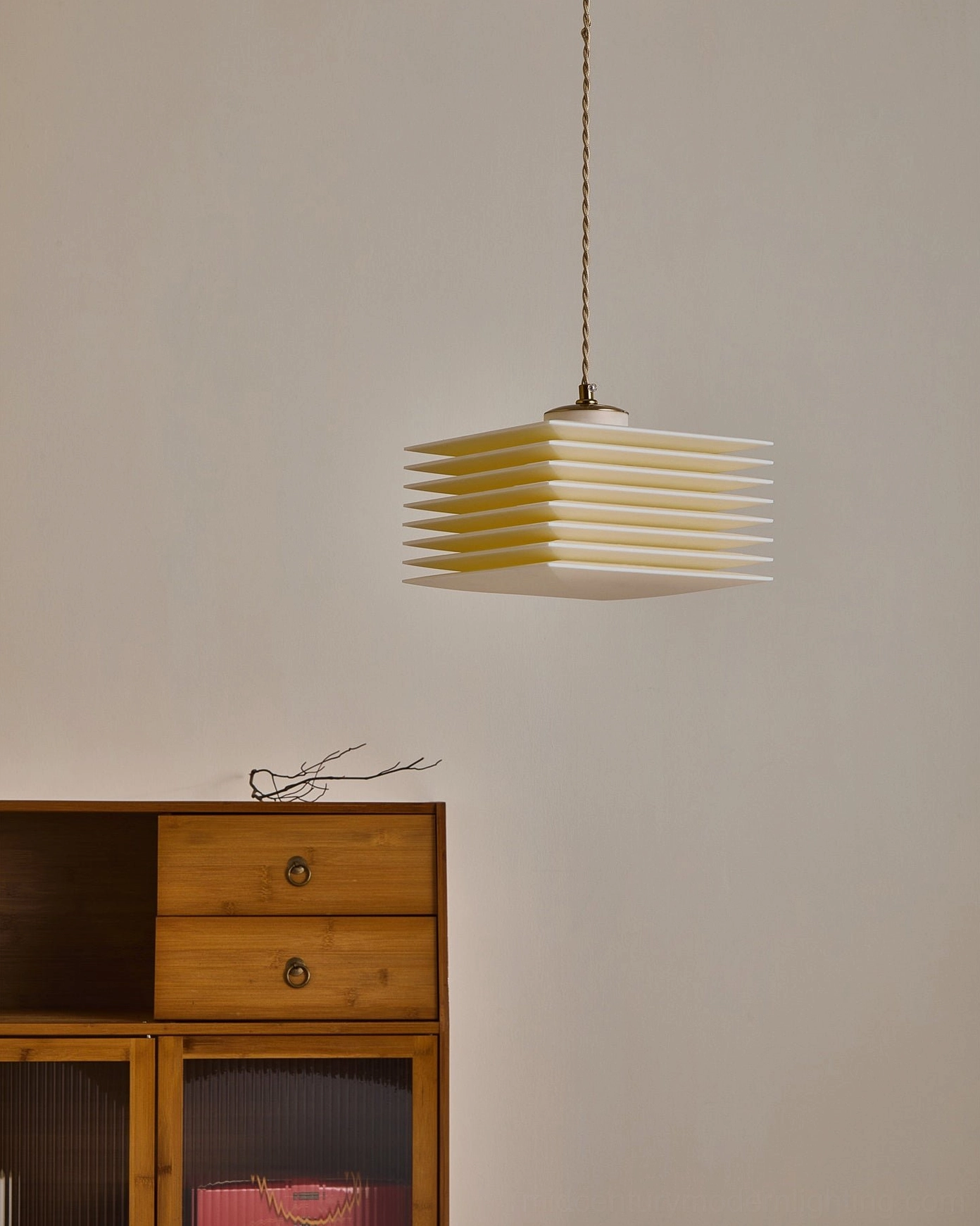 Side profile of pagoda pendant lamp with twisted gold suspension cord in contemporary room