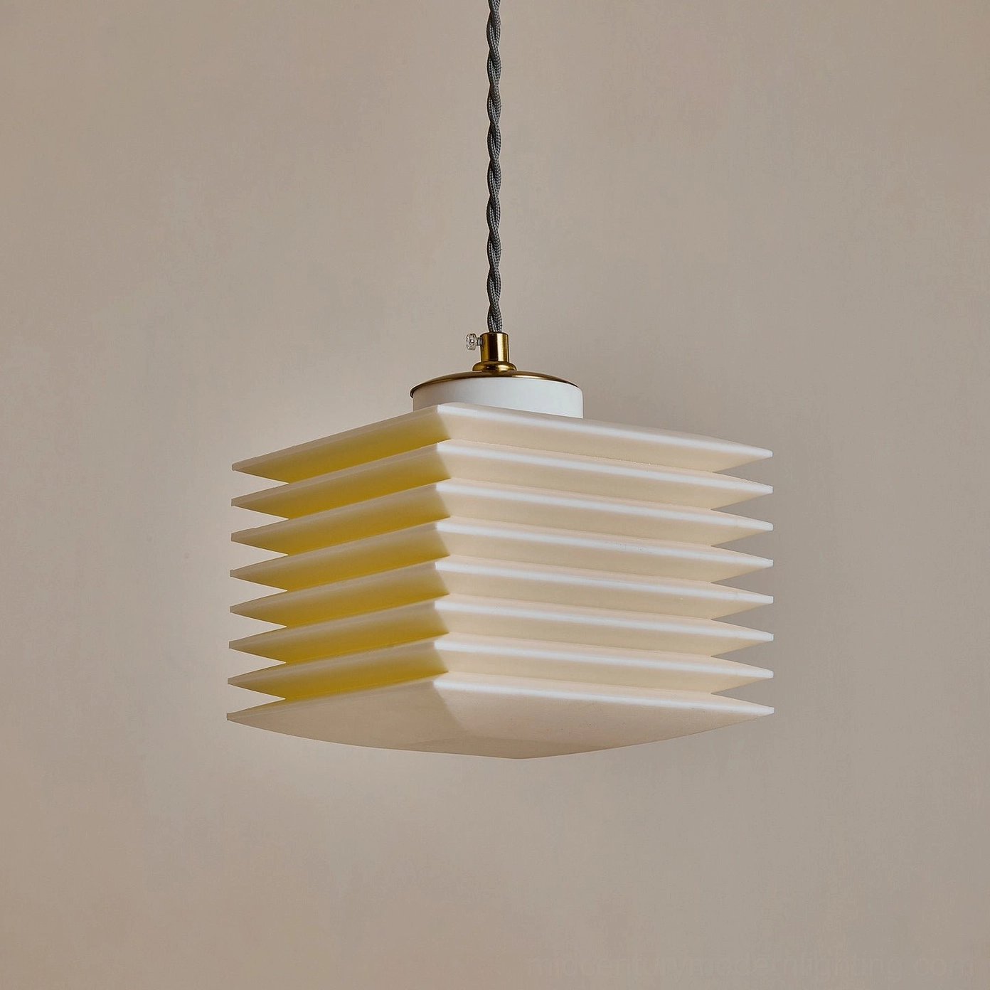 Pagoda pendant lamp unlit showcasing clean matte white geometric design against beige wall