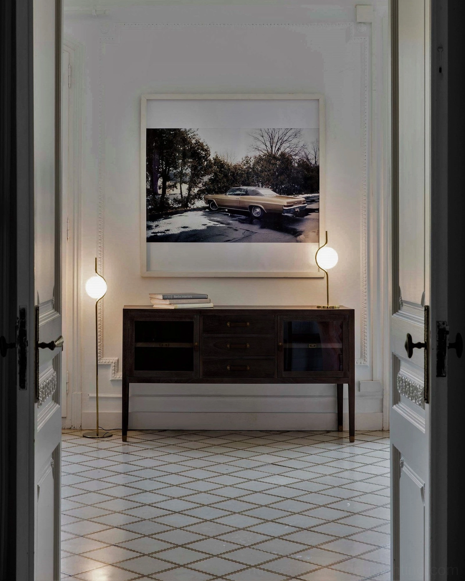Pair of matching Levita table lamps symmetrically placed on dark wood console table in modern entryway hallway