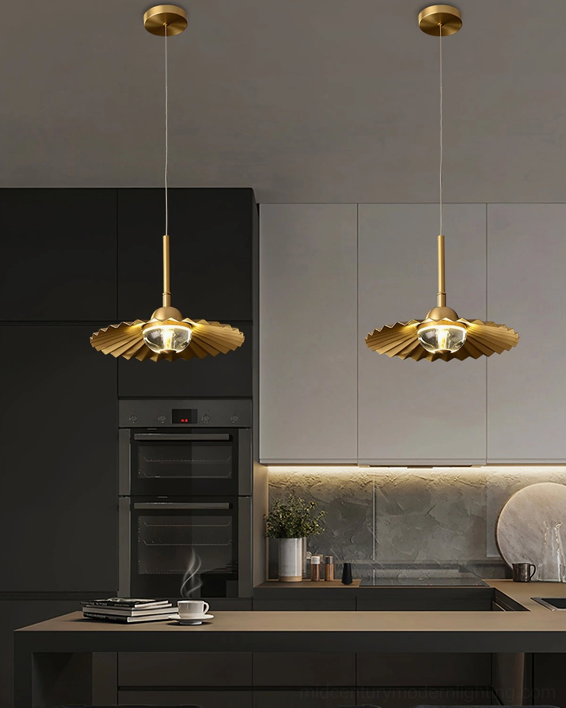 Pair of matching plié brass pendant lights illuminating modern kitchen dining counter with warm gold finish