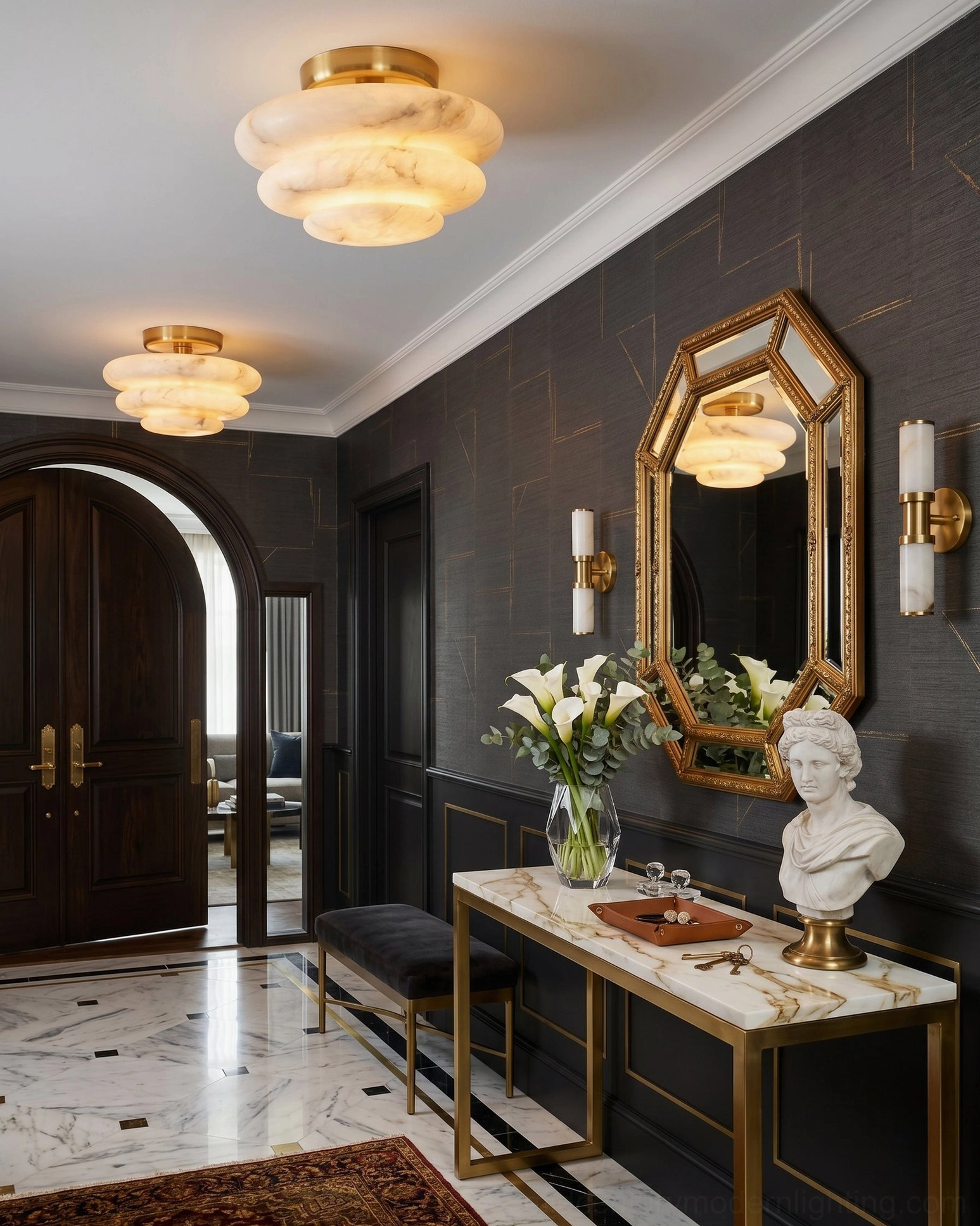 Paired alabaster ceiling mounts in dark foyer - gold decorative mirror - marble console table - luxury entry