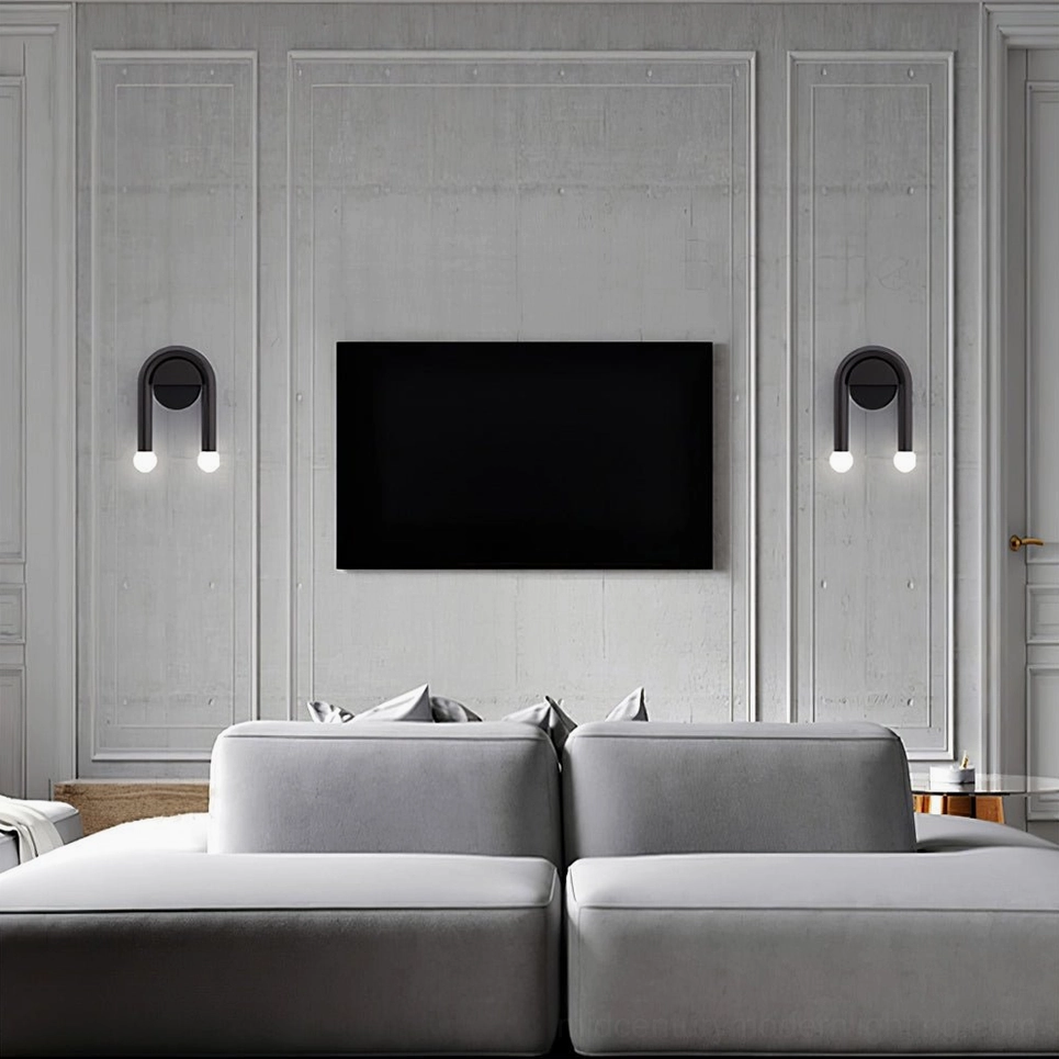 Pair of mid-century arched wall lamps flanking TV lounge area with gray contemporary sectional sofa