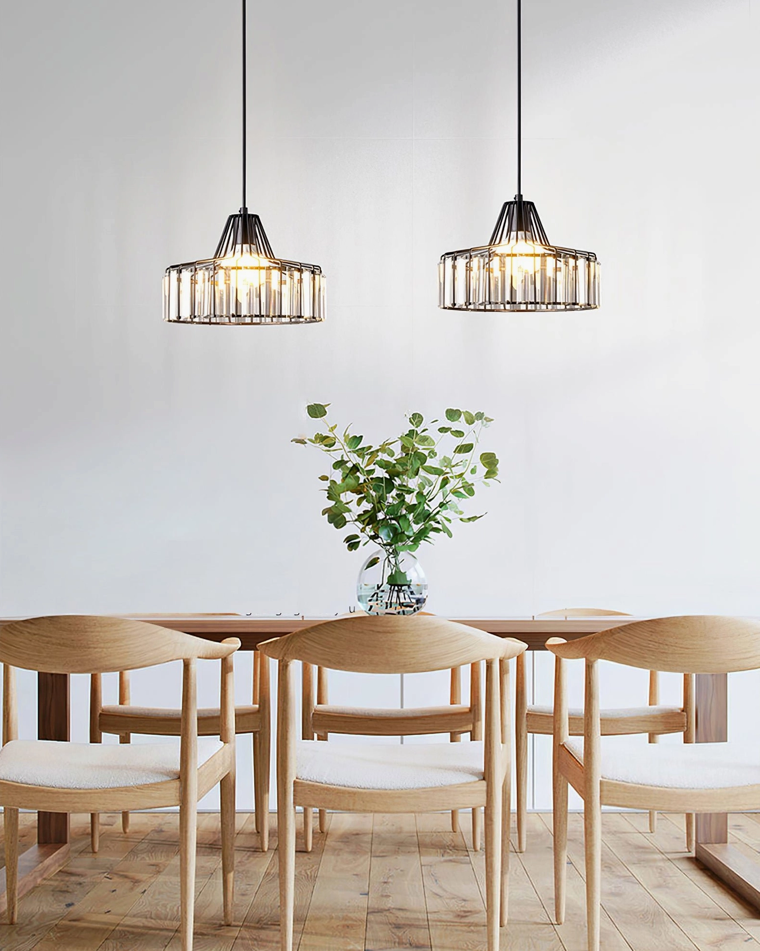 Two crystal pendant lamps suspended over wooden dining set in minimalist bright dining space