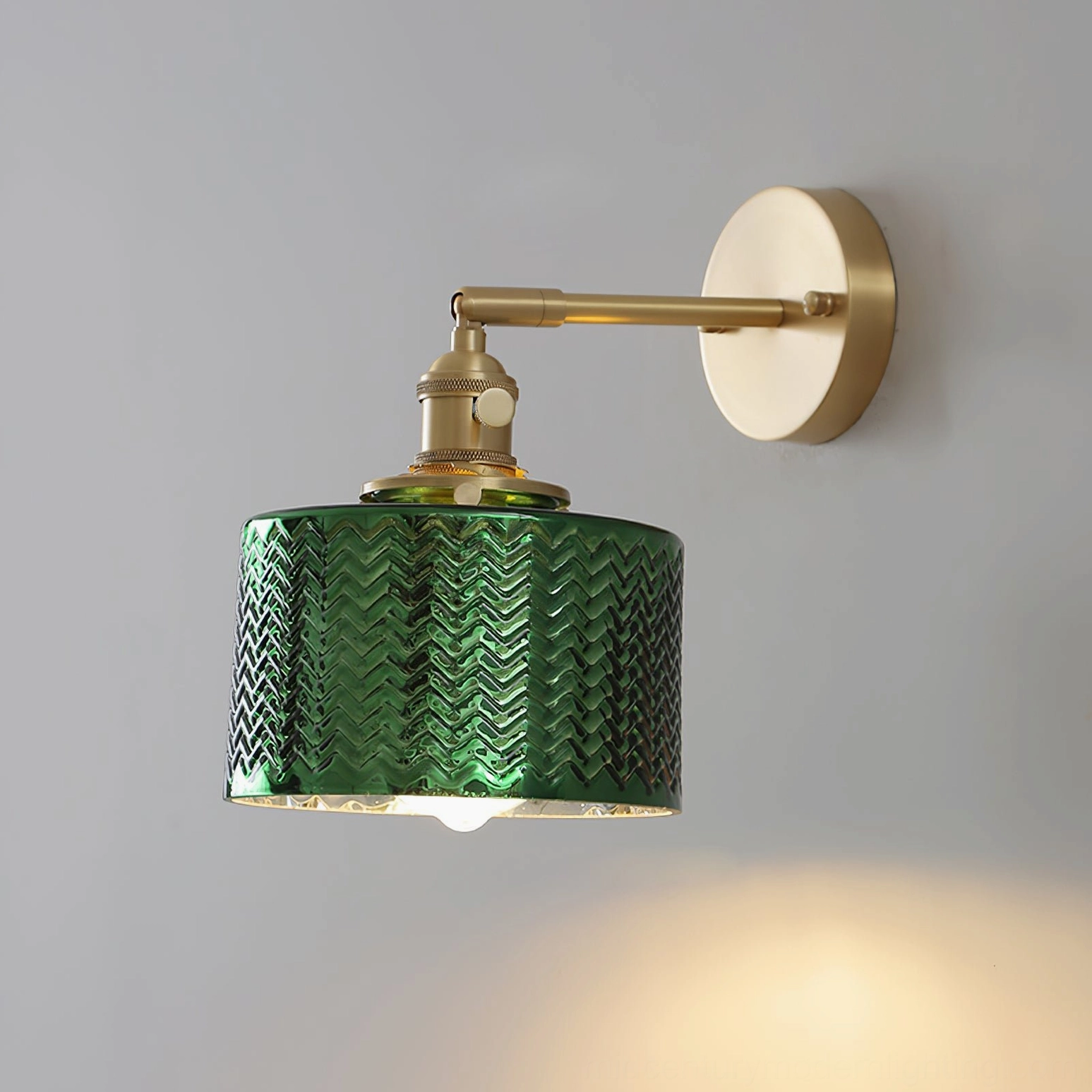 Paired green glass wall sconces creating symmetrical gallery lighting arrangement