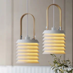 Two matching tiered pendant lamps with warm glowing honeycomb structure in home interior corner setting