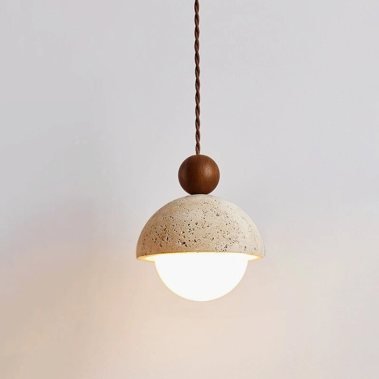 Front view of Palermo travertine pendant with illuminated glass globe interior