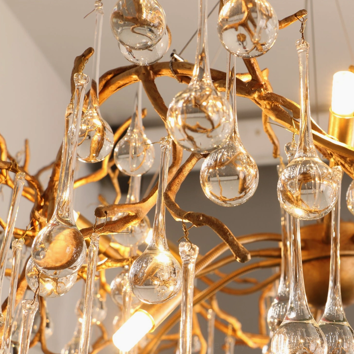 Palwa chandelier close-up details warm glowing bulbs mixed glass pieces indoor