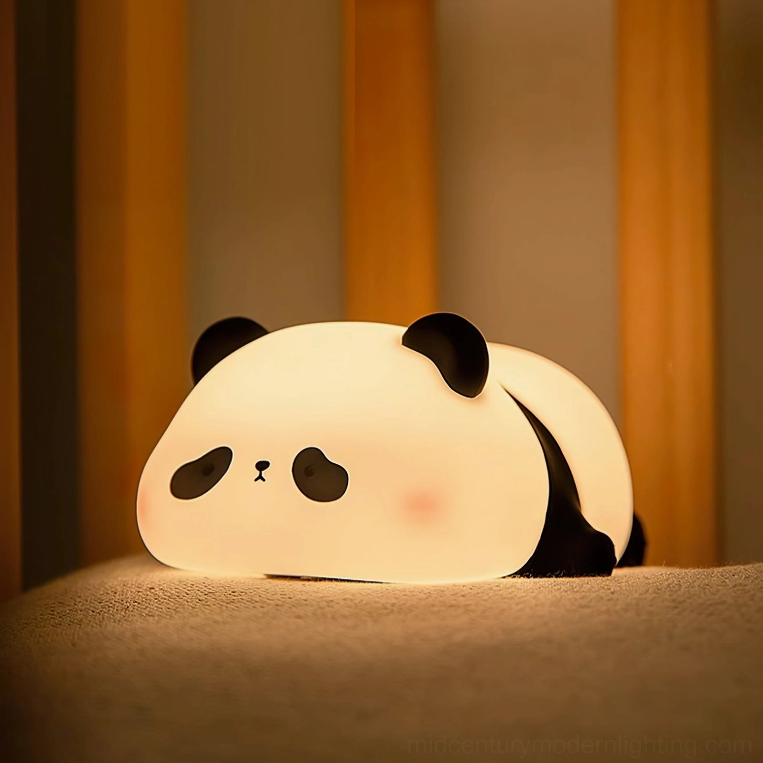 Panda night light glowing softly under cozy bed linens creating warm bedroom ambiance
