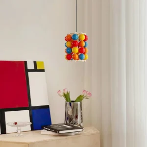 Modern colorful Panton ball pendant lamp hanging in contemporary home interior above dining area with Mondrian wall art